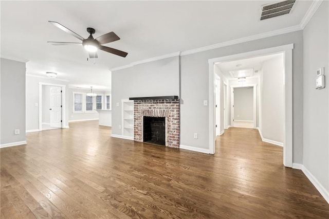 unfurnished living room featuring ornamental molding, dark wood-type flooring, visible vents, and a ceiling fan