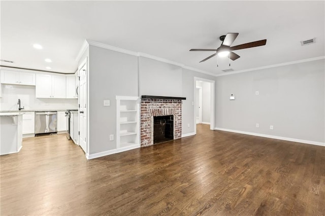 unfurnished living room featuring a fireplace, wood finished floors, and baseboards