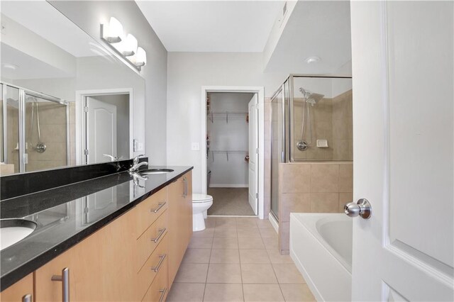 full bathroom with vanity, tile patterned floors, plus walk in shower, and toilet