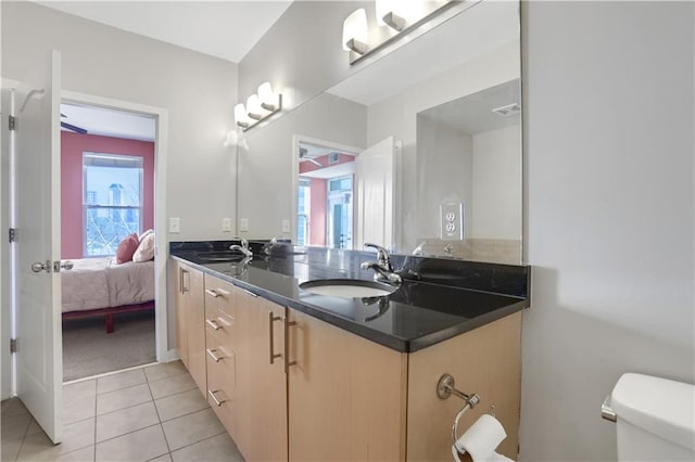 bathroom featuring vanity, tile patterned floors, and toilet