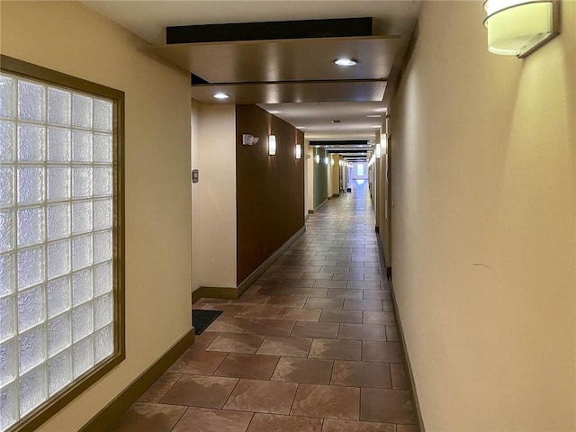 hallway featuring dark tile patterned floors