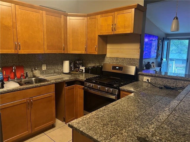 1506 Ravenel Rd, Conley, GA 30288 - kitchen with stainless steel range with gas stovetop, a sink, tile countertops, backsplash, and vaulted ceiling