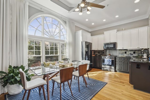 kitchen featuring white cabinetry, ornamental molding, appliances with stainless steel finishes, and sink