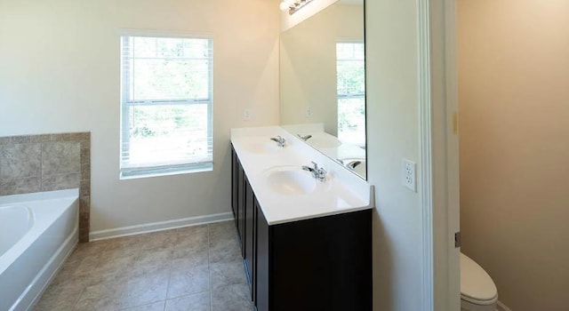 bathroom with vanity, toilet, a bathing tub, and tile patterned flooring