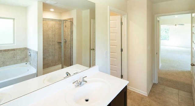 bathroom featuring tile patterned flooring, vanity, and plus walk in shower