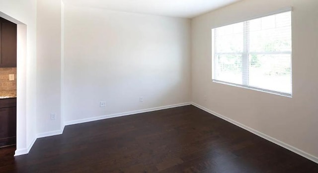 spare room featuring dark hardwood / wood-style floors