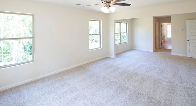 spare room with light colored carpet and ceiling fan