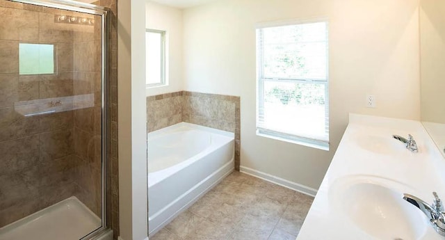 bathroom featuring tile patterned floors, shower with separate bathtub, and sink