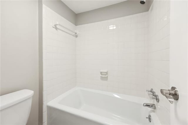 bathroom featuring toilet and shower / bathing tub combination