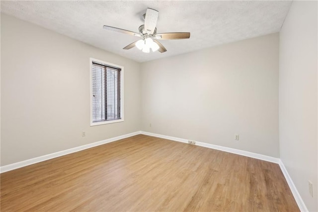 unfurnished room featuring ceiling fan, a textured ceiling, and light wood-type flooring