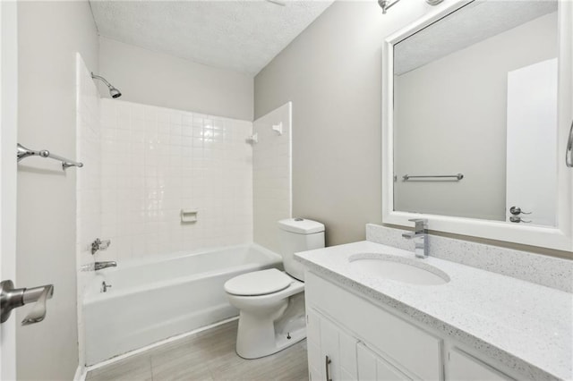 full bathroom with toilet, wood-type flooring, a textured ceiling, vanity, and shower / bath combination