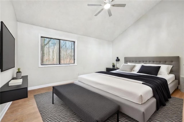 bedroom featuring ceiling fan, vaulted ceiling, and light hardwood / wood-style floors