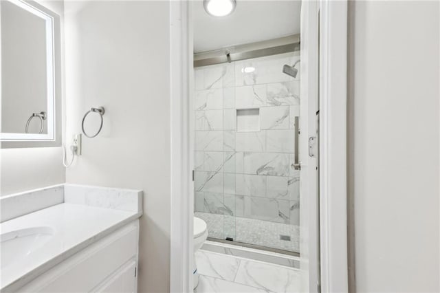 bathroom featuring vanity, toilet, and walk in shower