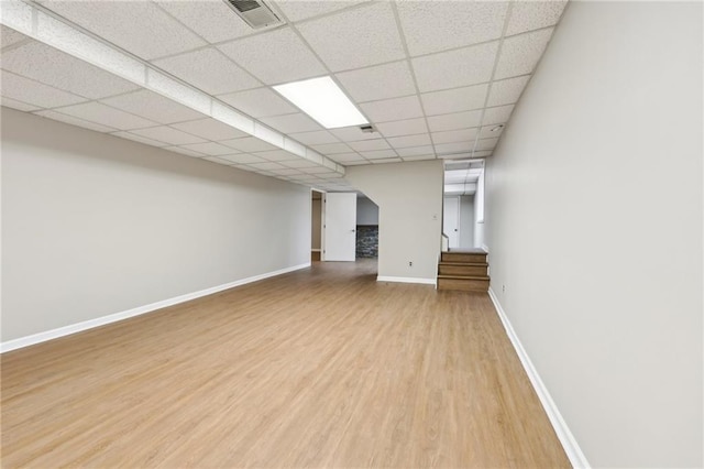 basement featuring wood-type flooring and a drop ceiling