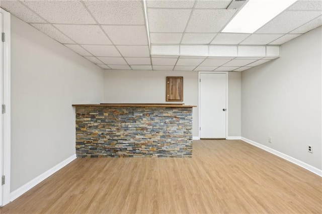 interior space with bar and light hardwood / wood-style flooring