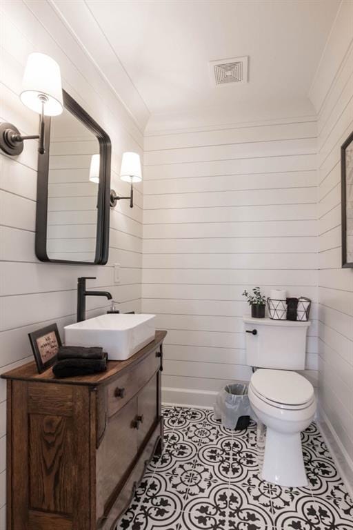 bathroom featuring toilet, vanity, and tile patterned flooring