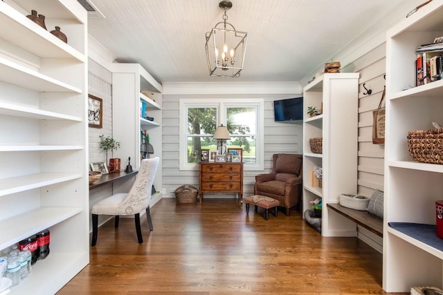 living area featuring wood finished floors and a chandelier