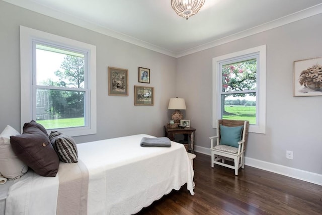 bedroom featuring multiple windows, dark wood-style flooring, ornamental molding, and baseboards