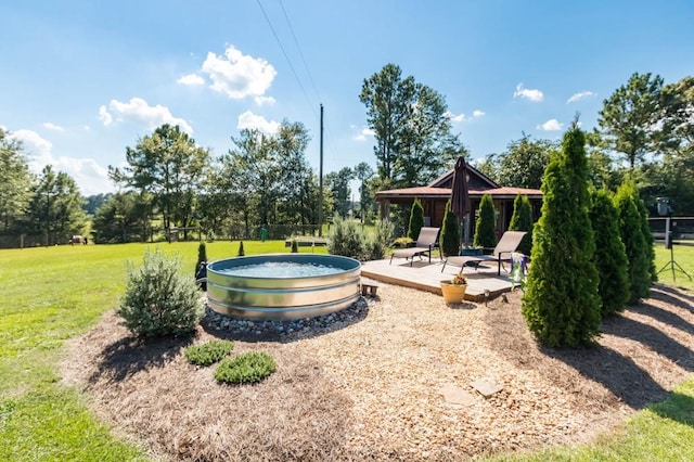 view of community with a yard and a patio area
