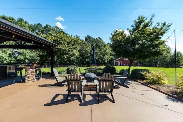 view of patio featuring a gazebo and view of scattered trees