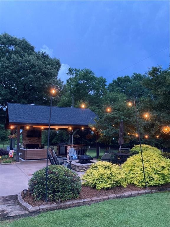 view of community featuring an outdoor fire pit