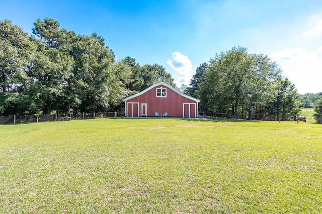 view of yard featuring an outbuilding, a detached garage, and an outdoor structure