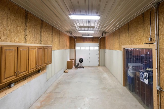 garage featuring a wainscoted wall