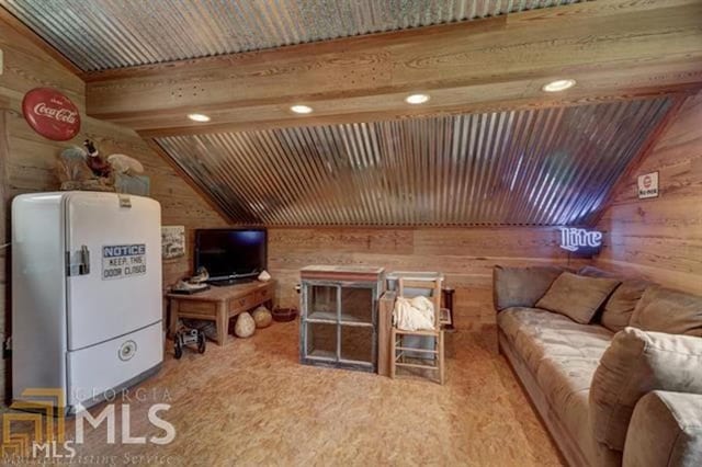 living room with wooden walls, vaulted ceiling, and recessed lighting