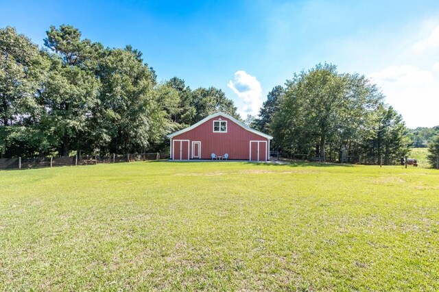 view of yard featuring an outbuilding and a detached garage
