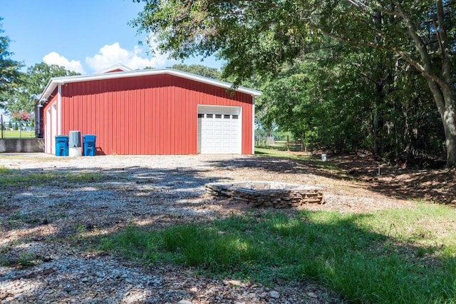 detached garage with gravel driveway