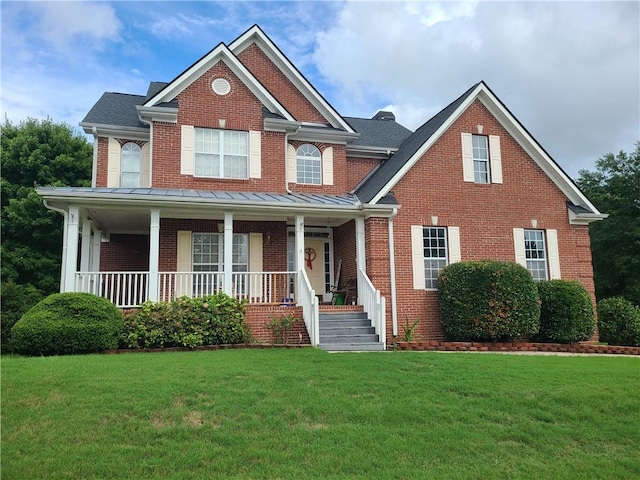 view of front of house featuring covered porch and a front lawn