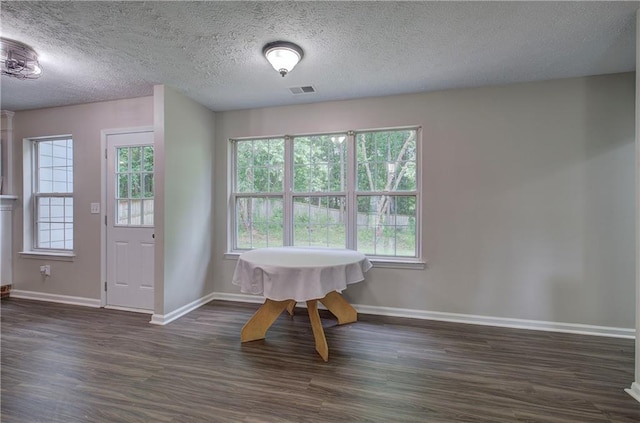 4975 Rockstone Way, Acworth, GA 30101 - dining area with dark wood-style floors, healthy amount of natural light, and a textured ceiling