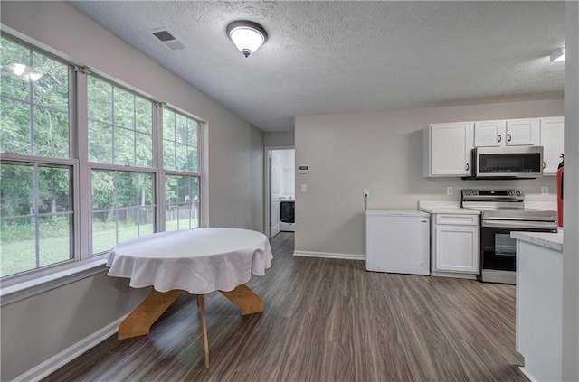 4975 Rockstone Way, Acworth, GA 30101 - kitchen with appliances with stainless steel finishes, dark wood finished floors, light countertops, a textured ceiling, and white cabinets