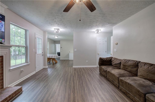 4975 Rockstone Way, Acworth, GA 30101 - living room with wood finished floors, ceiling fan, a textured ceiling, and a brick fireplace