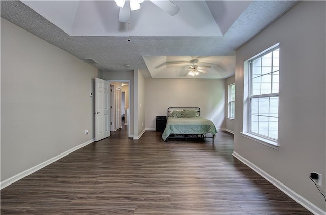 4975 Rockstone Way, Acworth, GA 30101 - bedroom featuring a tray ceiling, dark wood-style floors, a textured ceiling, and ceiling fan