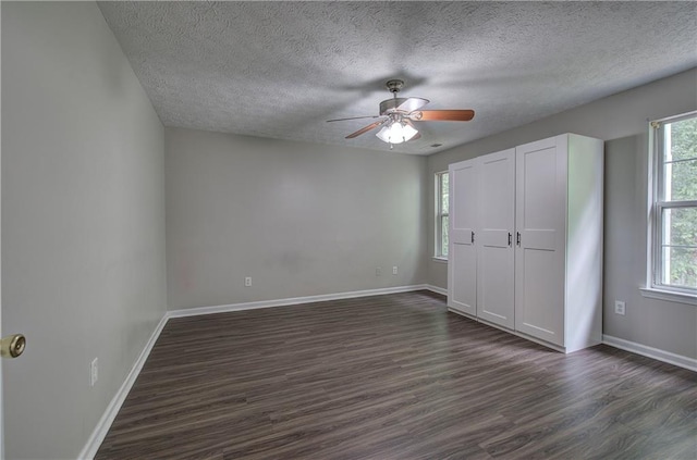 4975 Rockstone Way, Acworth, GA 30101 - unfurnished bedroom featuring dark wood finished floors, a textured ceiling, and a ceiling fan