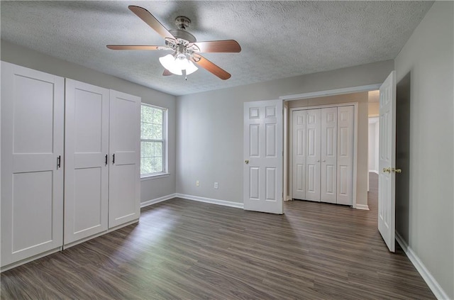 4975 Rockstone Way, Acworth, GA 30101 - unfurnished bedroom featuring a textured ceiling, dark wood-style floors, ceiling fan, and a closet