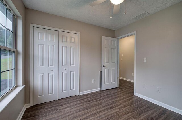 4975 Rockstone Way, Acworth, GA 30101 - unfurnished bedroom with dark wood-style flooring, a closet, a textured ceiling, and ceiling fan