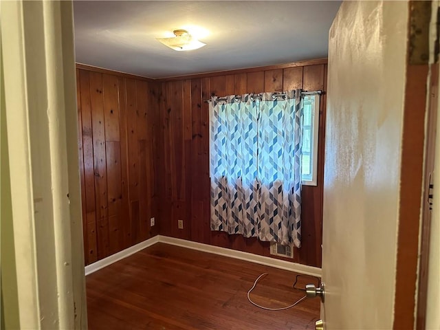1681 SW Hammond Woods Cir SW, Marietta, GA 30008 - spare room featuring dark wood-type flooring, baseboards, and wooden walls