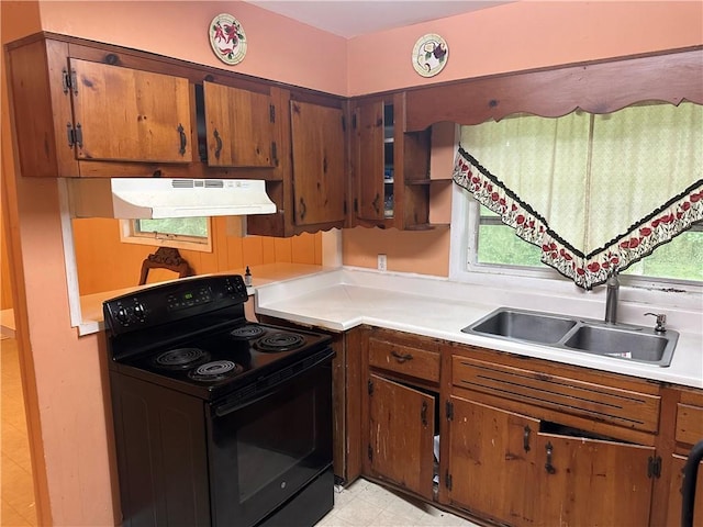 1681 SW Hammond Woods Cir SW, Marietta, GA 30008 - kitchen featuring black electric range, under cabinet range hood, a sink, light countertops, and brown cabinetry