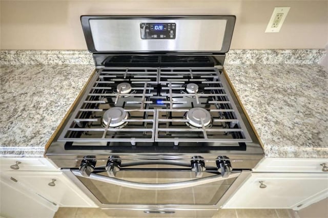 interior details with light countertops and gas range oven