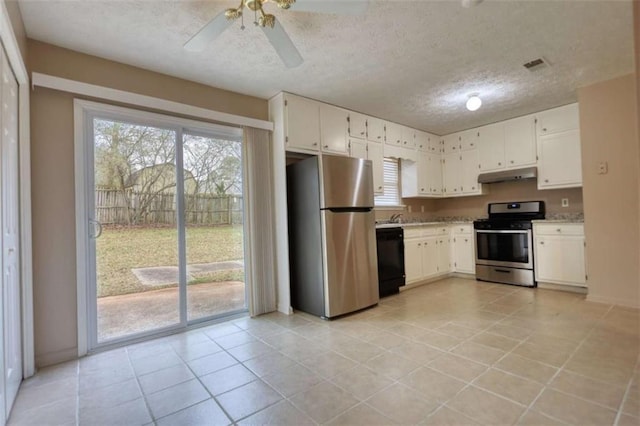 kitchen with under cabinet range hood, plenty of natural light, appliances with stainless steel finishes, and light countertops