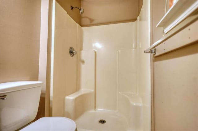 bathroom with toilet and walk in shower