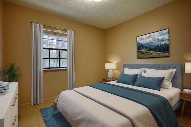 bedroom with a textured ceiling and baseboards