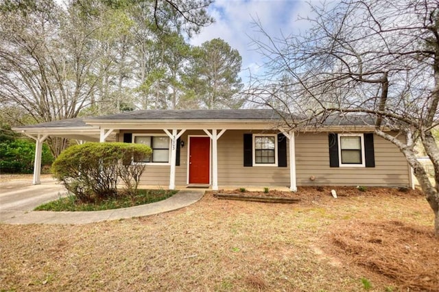 ranch-style home with a carport and concrete driveway