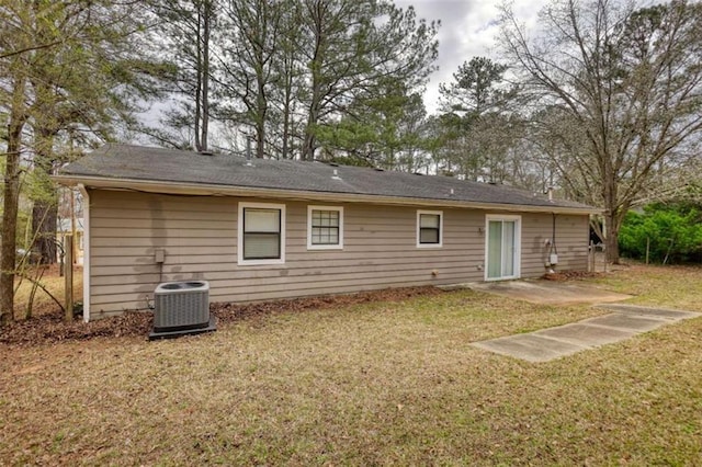 back of house featuring a lawn and central AC unit