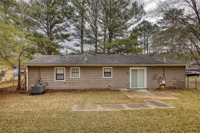 rear view of house with fence, a lawn, a patio, and central AC unit