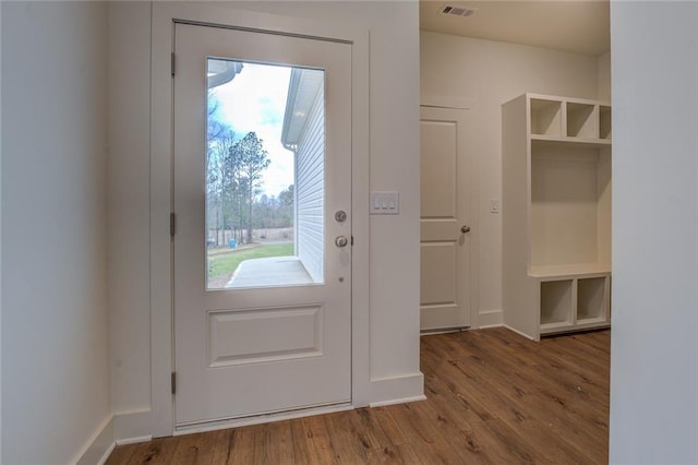 entryway featuring wood finished floors, visible vents, and baseboards