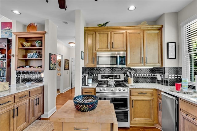 2176 Pine Lake Rd, Hiawassee, GA 30546 - kitchen featuring stainless steel appliances, open shelves, a sink, tasteful backsplash, and light wood-style floors