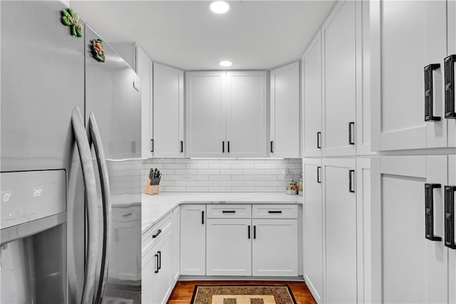 2176 Pine Lake Rd, Hiawassee, GA 30546 - kitchen with stainless steel refrigerator with ice dispenser, white cabinetry, light stone countertops, recessed lighting, and wood finished floors